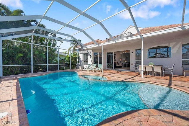 view of swimming pool with a lanai, a patio, and an in ground hot tub