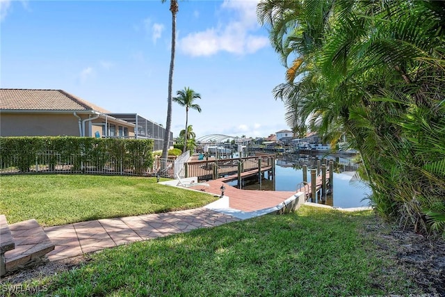 view of dock featuring a water view and a yard