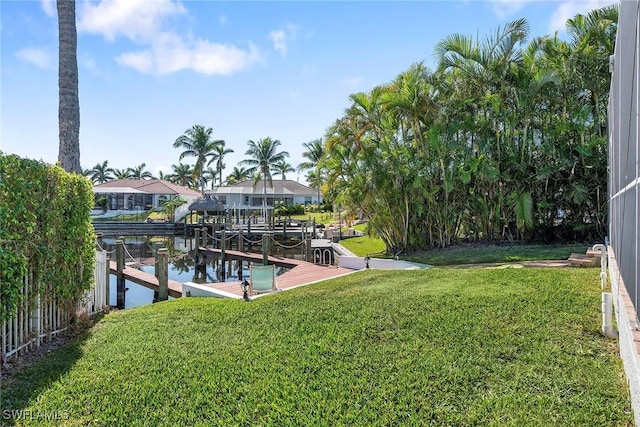 view of yard featuring a water view and a dock