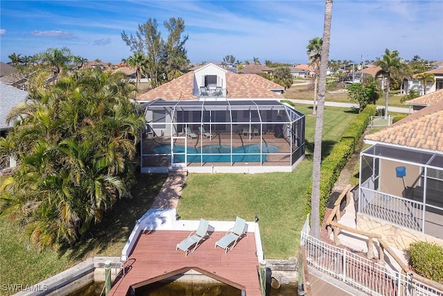 rear view of property with a yard, a lanai, and a patio area