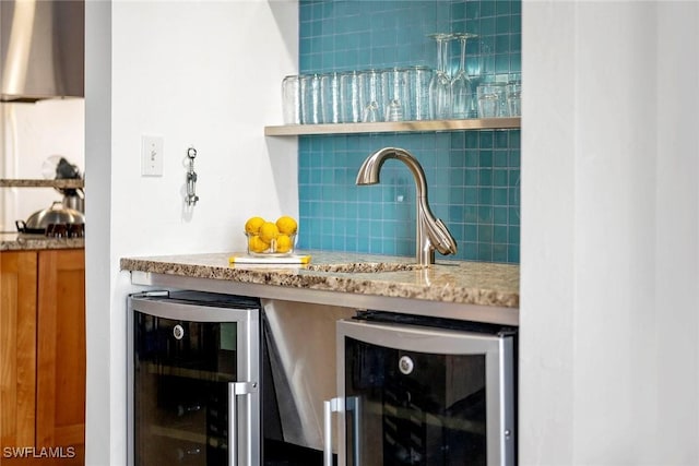 bar featuring tasteful backsplash, light stone countertops, and beverage cooler