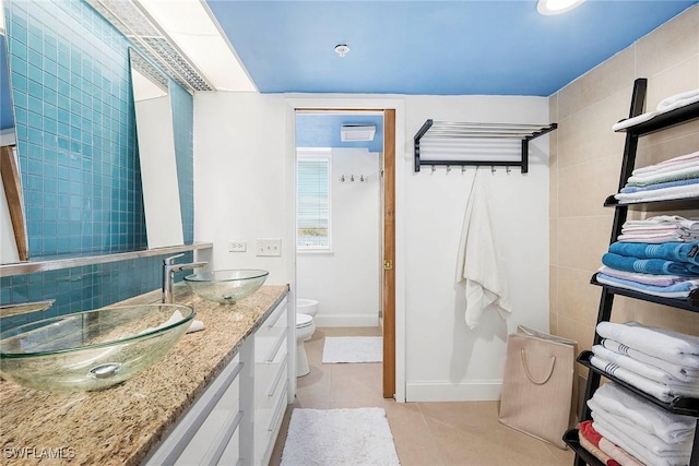 bathroom with vanity, tile patterned floors, and toilet