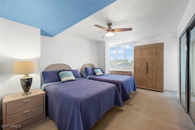 bedroom with ceiling fan and a closet