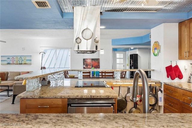 kitchen with light stone countertops and black electric cooktop