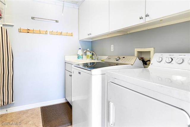 laundry room featuring cabinets, sink, tile patterned floors, and independent washer and dryer