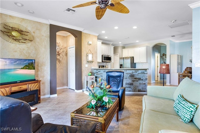 living room featuring ornamental molding, light tile patterned floors, and ceiling fan