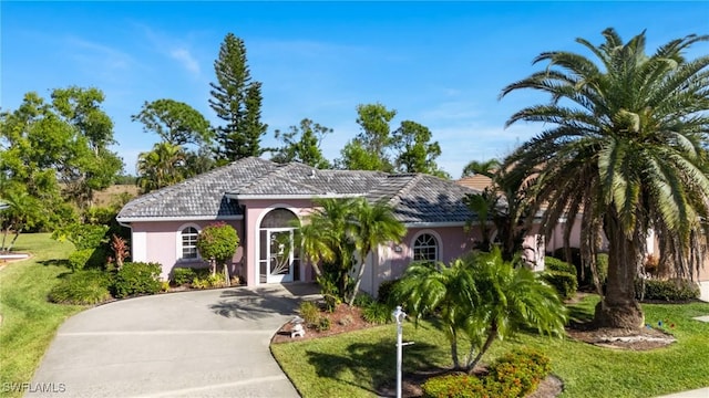 mediterranean / spanish house featuring a front lawn