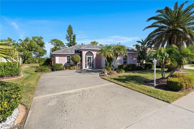 mediterranean / spanish house featuring a front yard