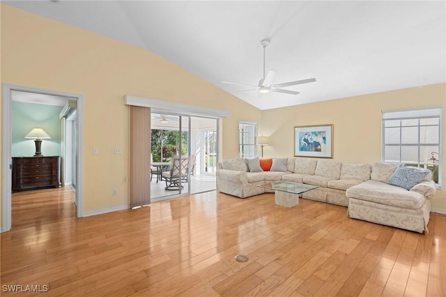 living room featuring high vaulted ceiling, ceiling fan, and light hardwood / wood-style flooring