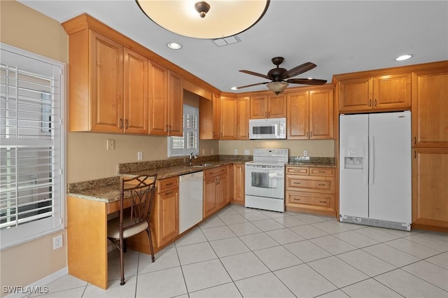 kitchen featuring light tile patterned flooring, sink, dark stone counters, ceiling fan, and white appliances