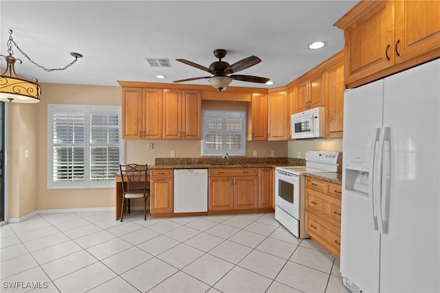 kitchen with sink, white appliances, ceiling fan, stone counters, and decorative light fixtures