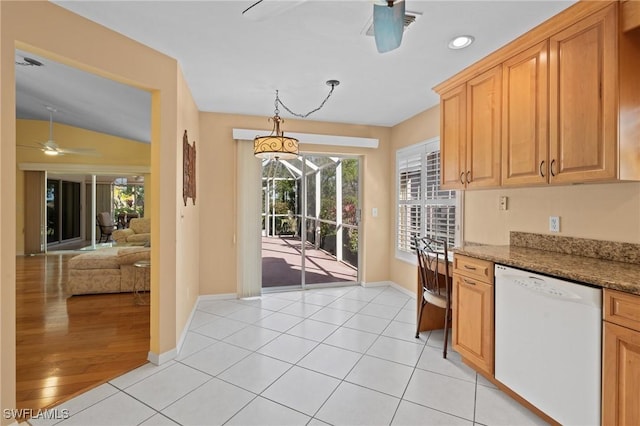 kitchen featuring stone counters, hanging light fixtures, light tile patterned floors, and white dishwasher