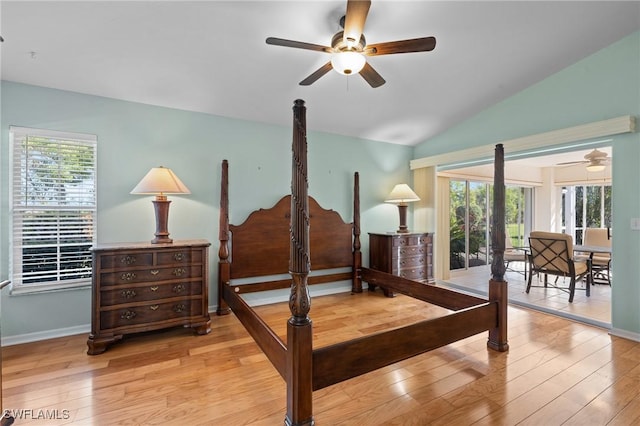 bedroom featuring multiple windows, lofted ceiling, and light hardwood / wood-style floors