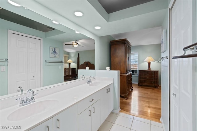 bathroom with tile patterned flooring, vanity, and ceiling fan