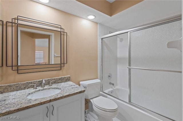 full bathroom with vanity, shower / bath combination with glass door, and toilet