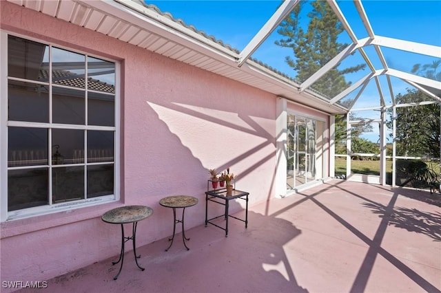 view of patio with glass enclosure