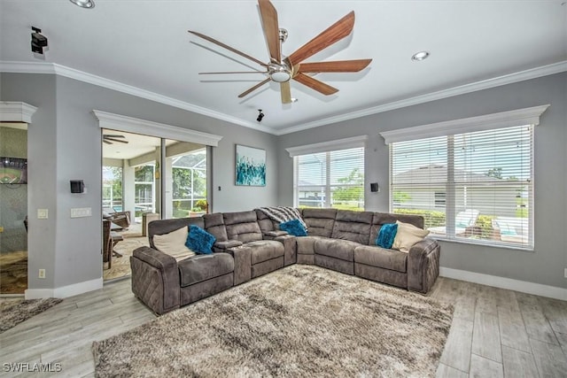 living room with crown molding, ceiling fan, and light hardwood / wood-style floors