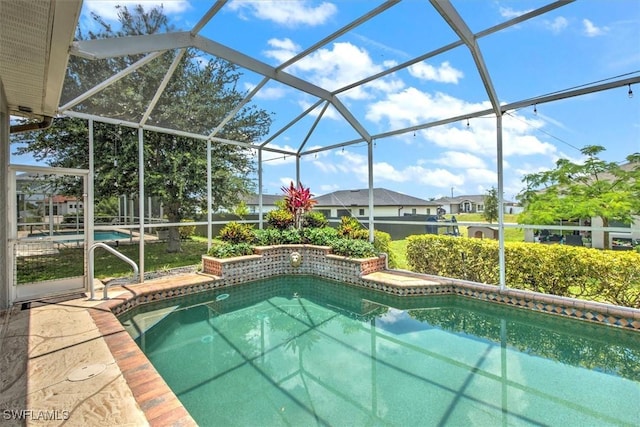 view of pool featuring glass enclosure