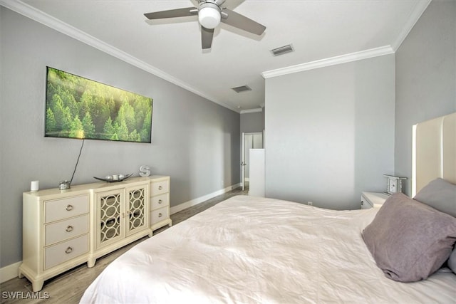 bedroom featuring ceiling fan, ornamental molding, and light wood-type flooring