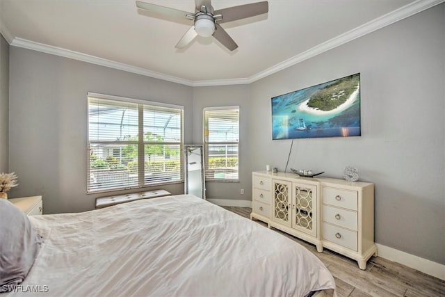 bedroom with light hardwood / wood-style flooring, ornamental molding, and ceiling fan