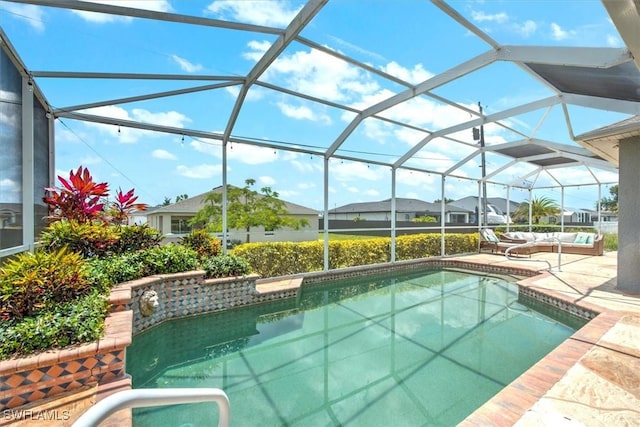 view of swimming pool featuring a patio area and glass enclosure