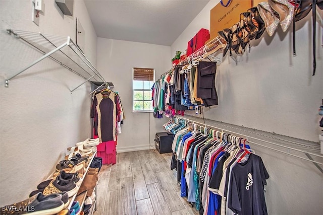 walk in closet featuring light hardwood / wood-style flooring