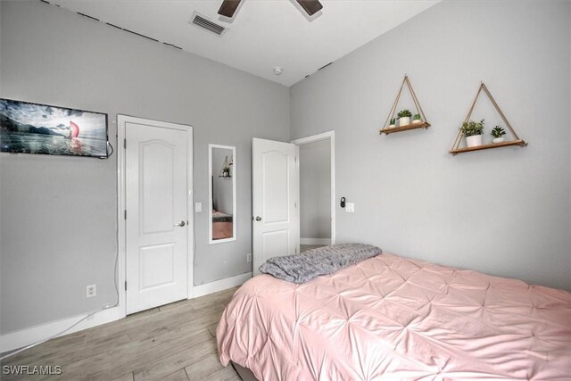 bedroom with ceiling fan and light wood-type flooring