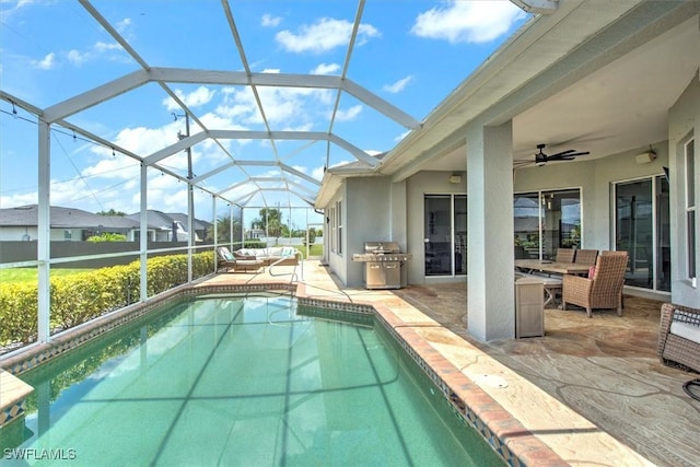 view of swimming pool featuring area for grilling, a lanai, a patio area, and ceiling fan