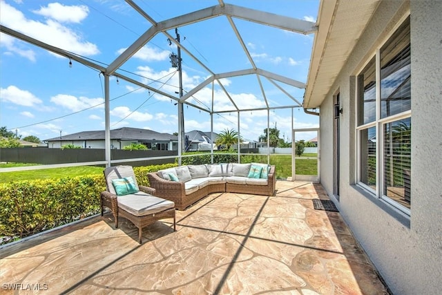 view of patio featuring an outdoor living space and glass enclosure