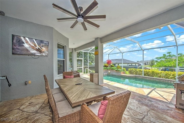 exterior space featuring ceiling fan, glass enclosure, and a patio