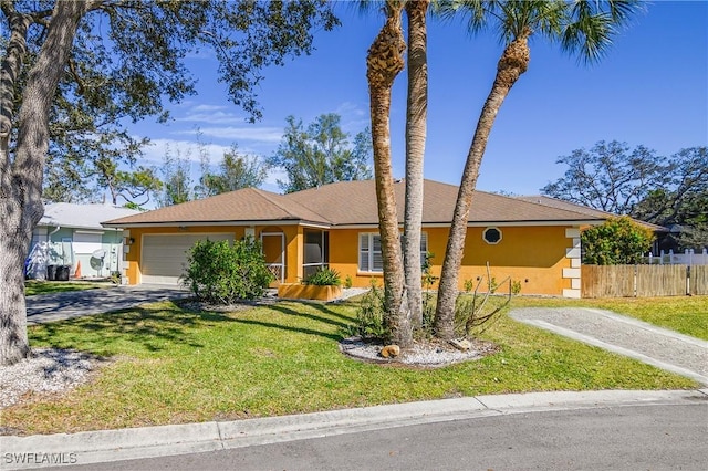 ranch-style house featuring driveway, a garage, stucco siding, fence, and a front yard