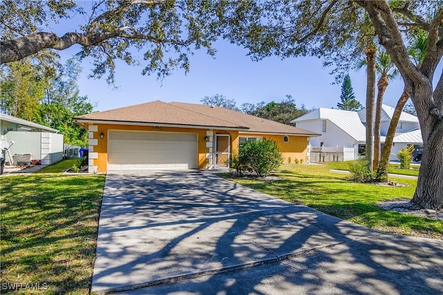 single story home featuring a garage and a front lawn