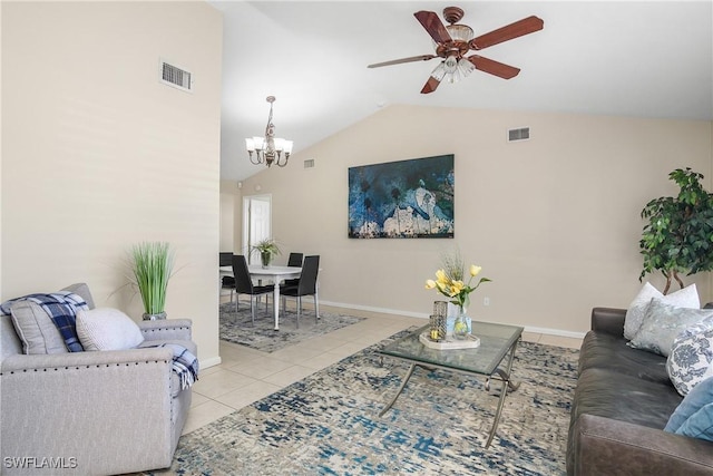 tiled living room featuring vaulted ceiling and ceiling fan with notable chandelier