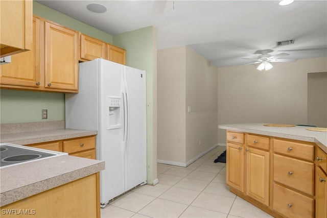 kitchen featuring light tile patterned floors, white refrigerator with ice dispenser, ceiling fan, and light brown cabinets