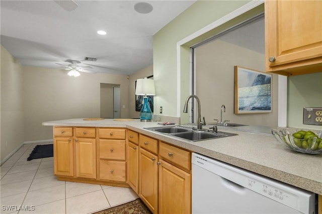 kitchen with light tile patterned flooring, kitchen peninsula, sink, ceiling fan, and white dishwasher