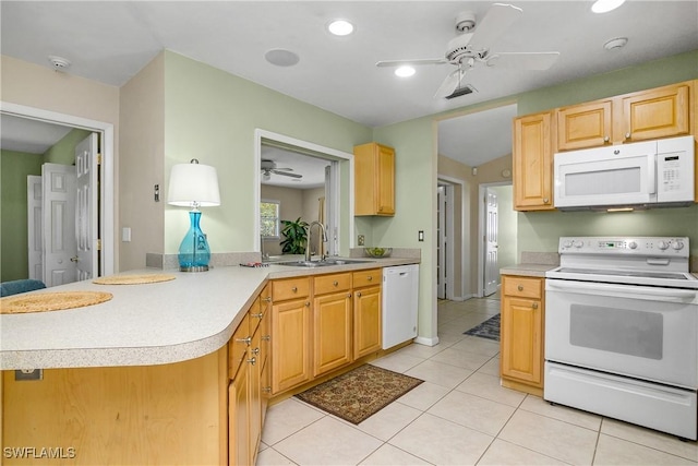 kitchen featuring sink, light tile patterned floors, kitchen peninsula, light brown cabinets, and white appliances