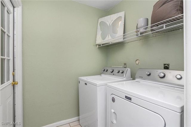 laundry room featuring light tile patterned flooring and washing machine and clothes dryer