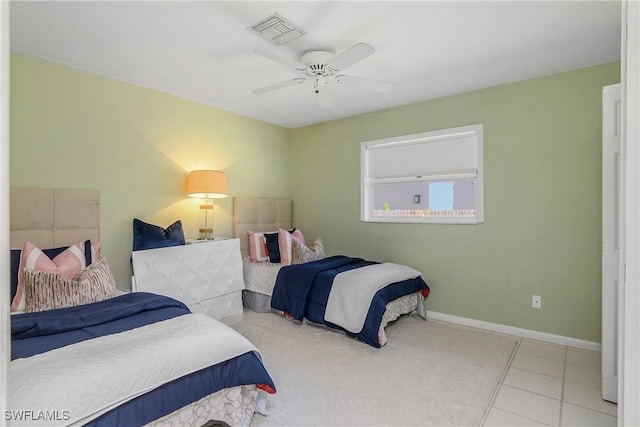 bedroom with ceiling fan and tile patterned floors