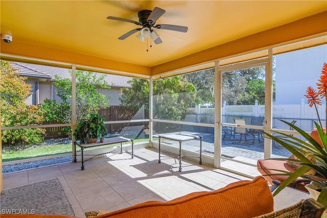 unfurnished sunroom featuring plenty of natural light and ceiling fan