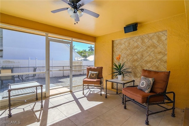 sunroom featuring tile patterned floors and a textured wall