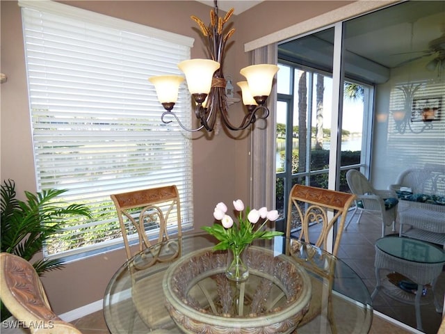 dining space featuring an inviting chandelier and tile patterned flooring