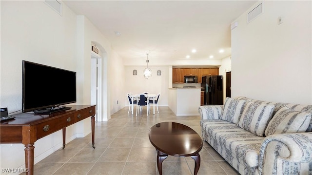 living room with light tile patterned floors, visible vents, and recessed lighting