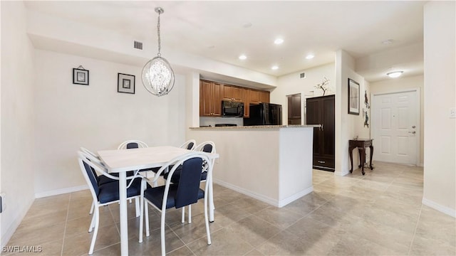 kitchen featuring visible vents, brown cabinetry, a peninsula, black appliances, and recessed lighting