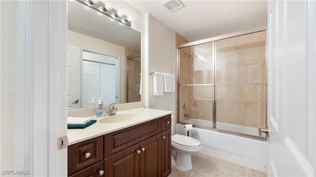 full bath featuring visible vents, toilet, tile patterned flooring, combined bath / shower with glass door, and vanity