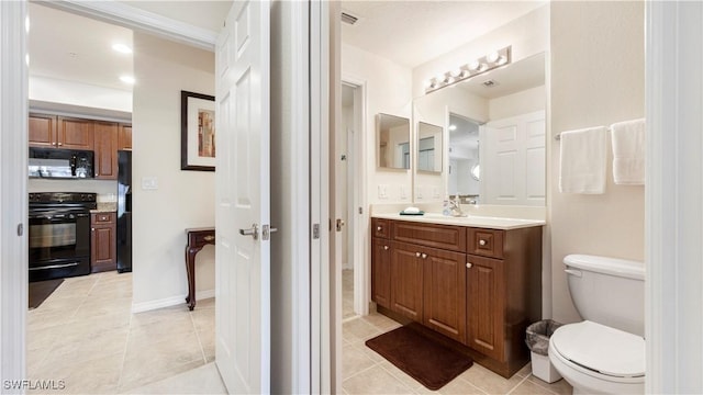 bathroom featuring toilet, tile patterned floors, and vanity