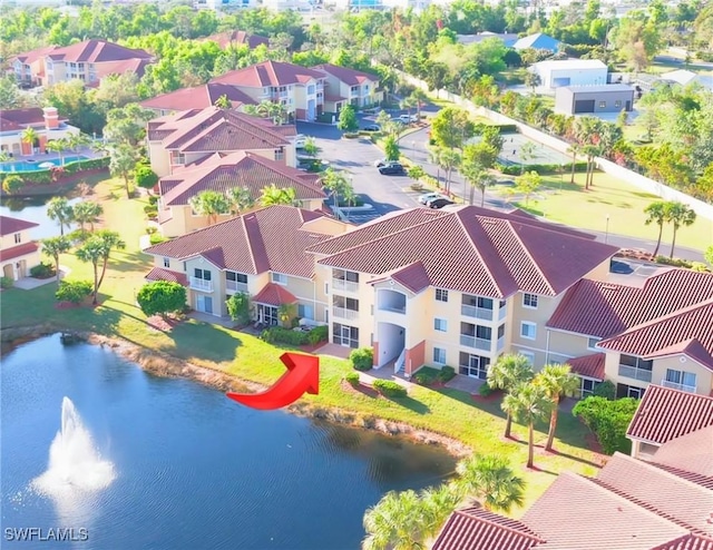 drone / aerial view featuring a water view and a residential view