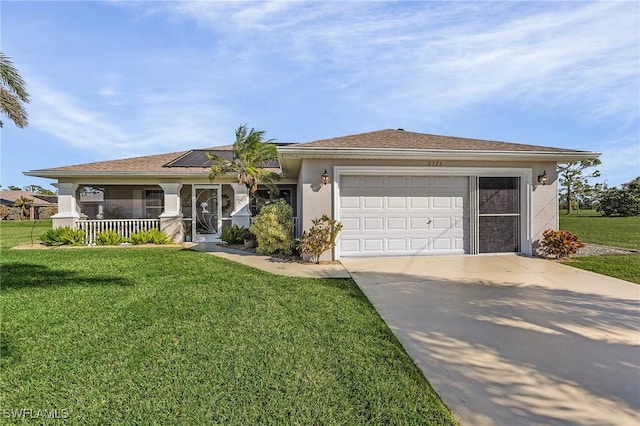 ranch-style home featuring a garage, covered porch, and a front lawn