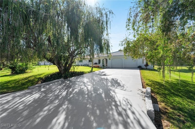 view of front of house with a garage and a front lawn