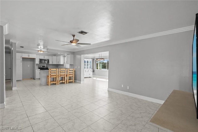 interior space featuring ceiling fan, ornamental molding, sink, and light tile patterned floors