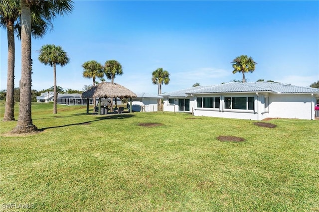 exterior space with a gazebo and a front yard